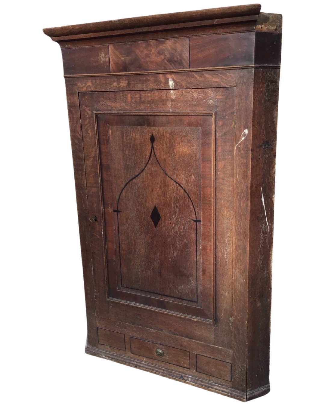 A nineteenth century oak corner cabinet with moulded cornice above a frieze set with mahogany