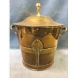 An arts & crafts lidded brass coal scuttle, with hand beaten heart shaped strapping and handles, the