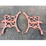 A pair of cast iron bench ends with scrolled arms, raised on channelled sabre legs - need re-