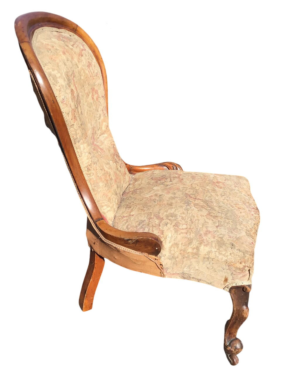 A Victorian mahogany upholstered spoonback chair with cushion moulded frame having carved terminals,