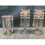 A pair of Victorian clear moulded glass lustre candlesticks with cut glass drops from scalloped