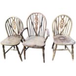 Three wheelback chairs with carver, the pierced splats framed by spindles above solid shaped