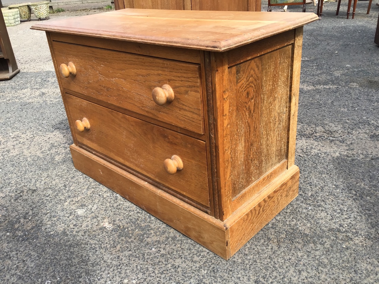 A low C20th oak chest of two knobbed drawers, with rectangular moulded top flanked by carved stiles, - Image 3 of 3