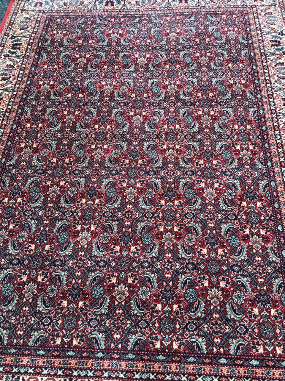 A Persian rug woven with field of busy paisley type floral decoration on red ground, within a frieze - Image 2 of 3