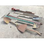 Miscellaneous garden tools including ditching spades, a rake, an old two-man log saw, a lift jack, a