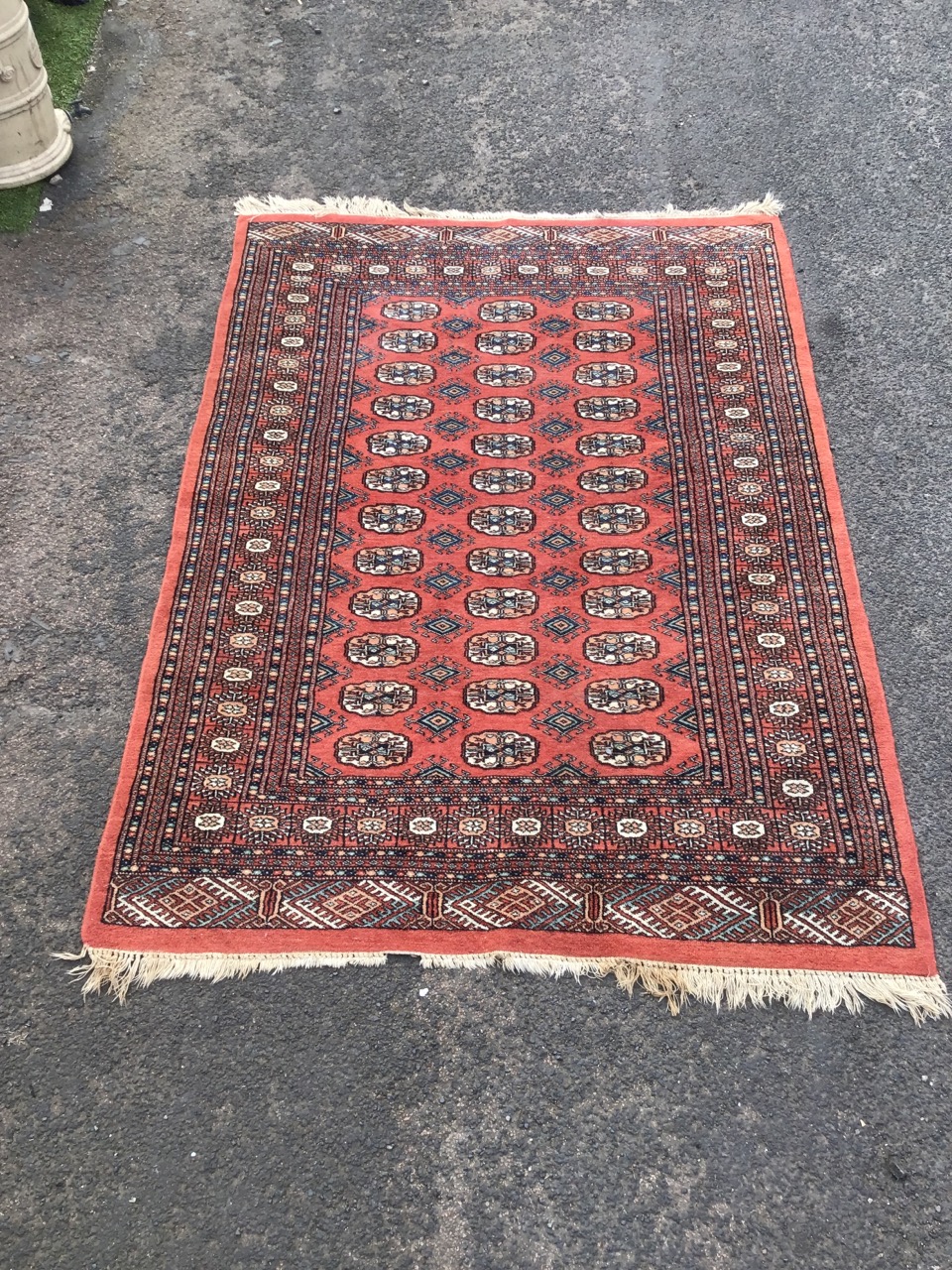 A bokarra type oriental rug woven with madder field of oval lozenges and hooked diamond - Image 2 of 3