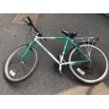 A Dawes Tracker bicycle with soft seat, panier rack, Shimano gears, Exage SLR brakes, etc.
