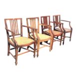 A set of four nineteenth century mahogany elbow chairs, the backs with moulded spindles beneath