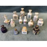 A collection of 19th century continental hand painted porcelain scent bottles and stoppers, with