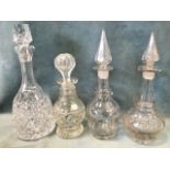 Three miscellaneous antique cut glass decanters and stoppers with star cut bases; and another of