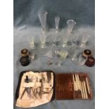 A collection of medical glassware and two cased surgical kits including conical measures, two