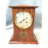 An Edwardian mahogany mantle clock by Reid & Sons, the waisted case having domed top inlaid with