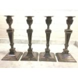 A set of four antique silver plated Adam style square candlesticks with urn shaped sconces and stiff
