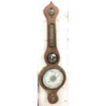 A nineteenth mahogany barometer with shaped case, having brass dry/damp dial above a thermometer and