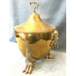 A Victorian brass coal bin raised on claw feet, mounted with mask ring handles, the domed cover with
