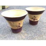 A pair of flared stoneware garden pots decorated with treacle glazed bands with sgraffito incised