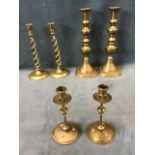 A pair of large Victorian brass candlesticks on square canted bases, the tubular candleholders