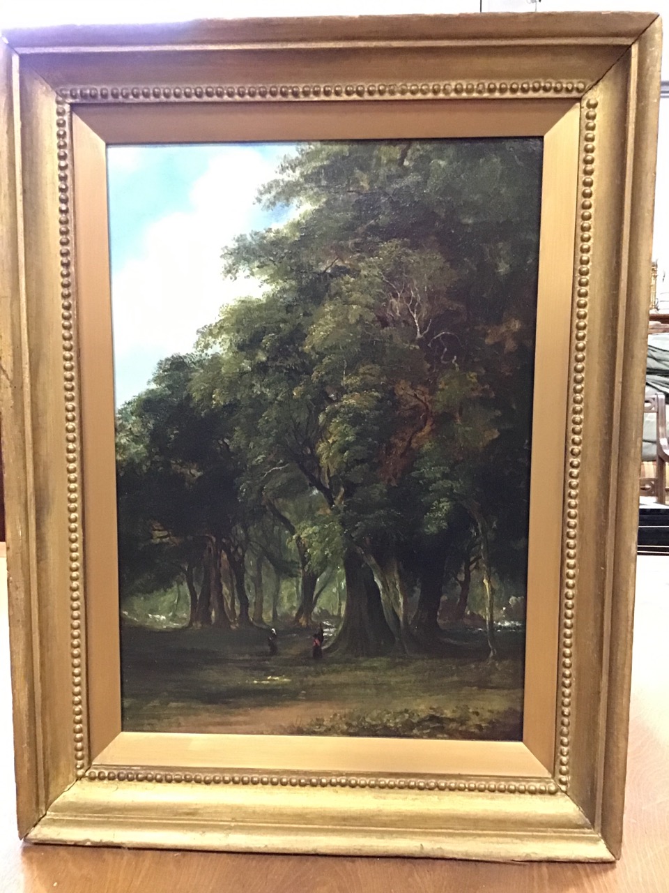 Nineteenth century oil on canvas, wooded landscape with two figures beneath trees, attributed to