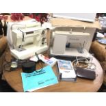 A New Home electronic sewing machine with soft cover and instruction manual; and a Singer 475 sewing