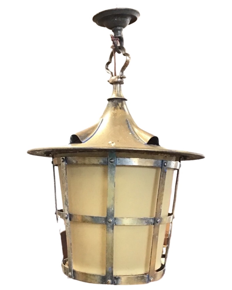 A hanging brass hall lantern with tapering cage shade beneath a circular canopy with four vents