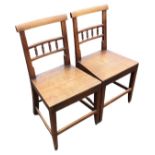 A pair of nineteenth century country oak side chairs, the bar backs with rows of turned gallery