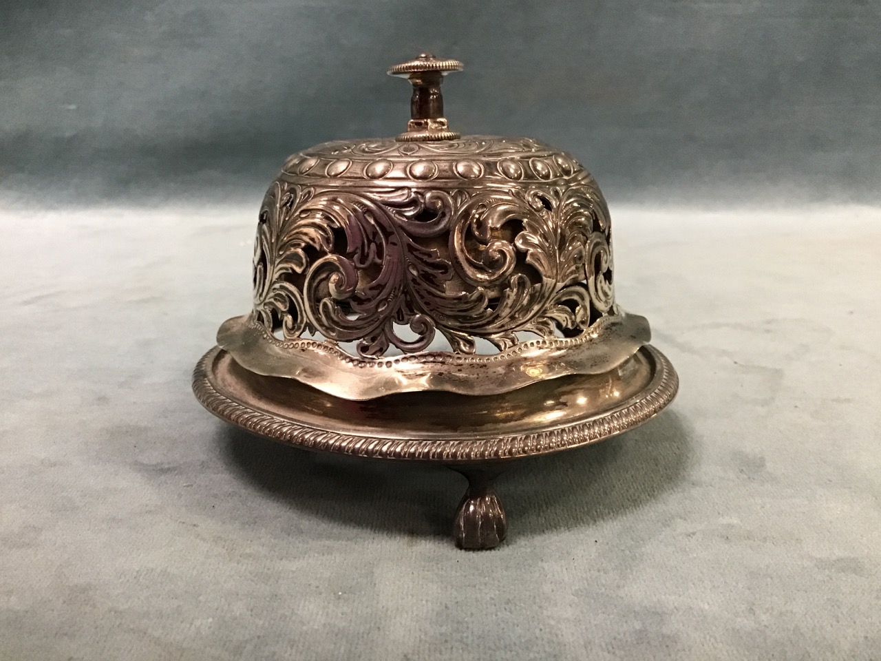 A Victorian pierced silver table bell, the domed cover on a circular gadrooned base raised on