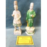 A Ming ceramic figure with sancai type glazed cloak standing on hexagonal plinth, with loose head;