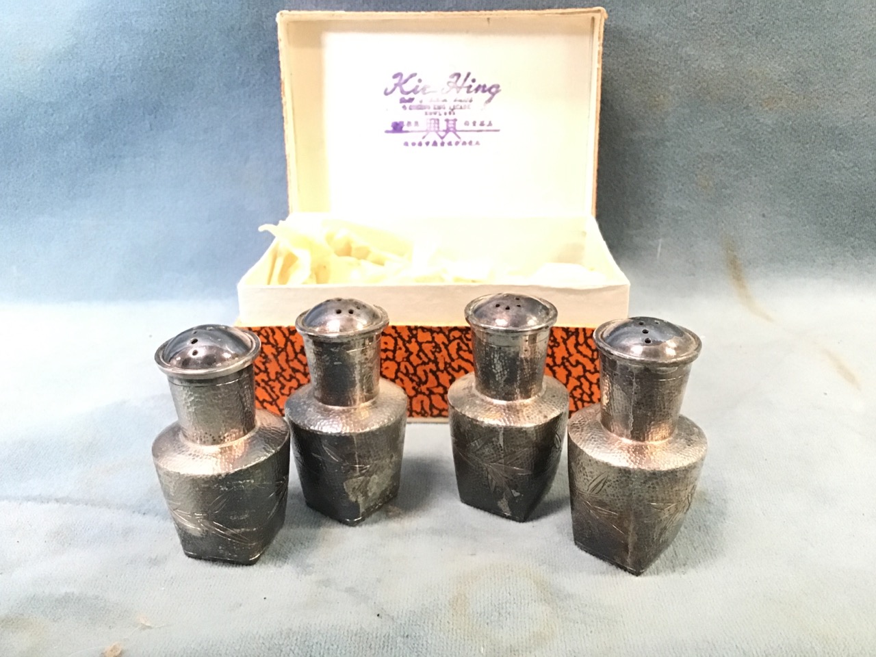 Two boxed pairs of sterling silver cruets of vase form, engraved with bamboo shoots on pounced