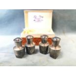 Two boxed pairs of sterling silver cruets of vase form, engraved with bamboo shoots on pounced