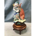 A Japanese porcelain model of a fisherman, the brightly clothed moustachioed gentleman with giant