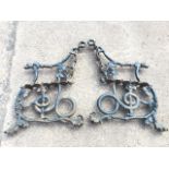 A pair of cast iron Coalbrookdale garden bench supports, the arms with hound head terminals and