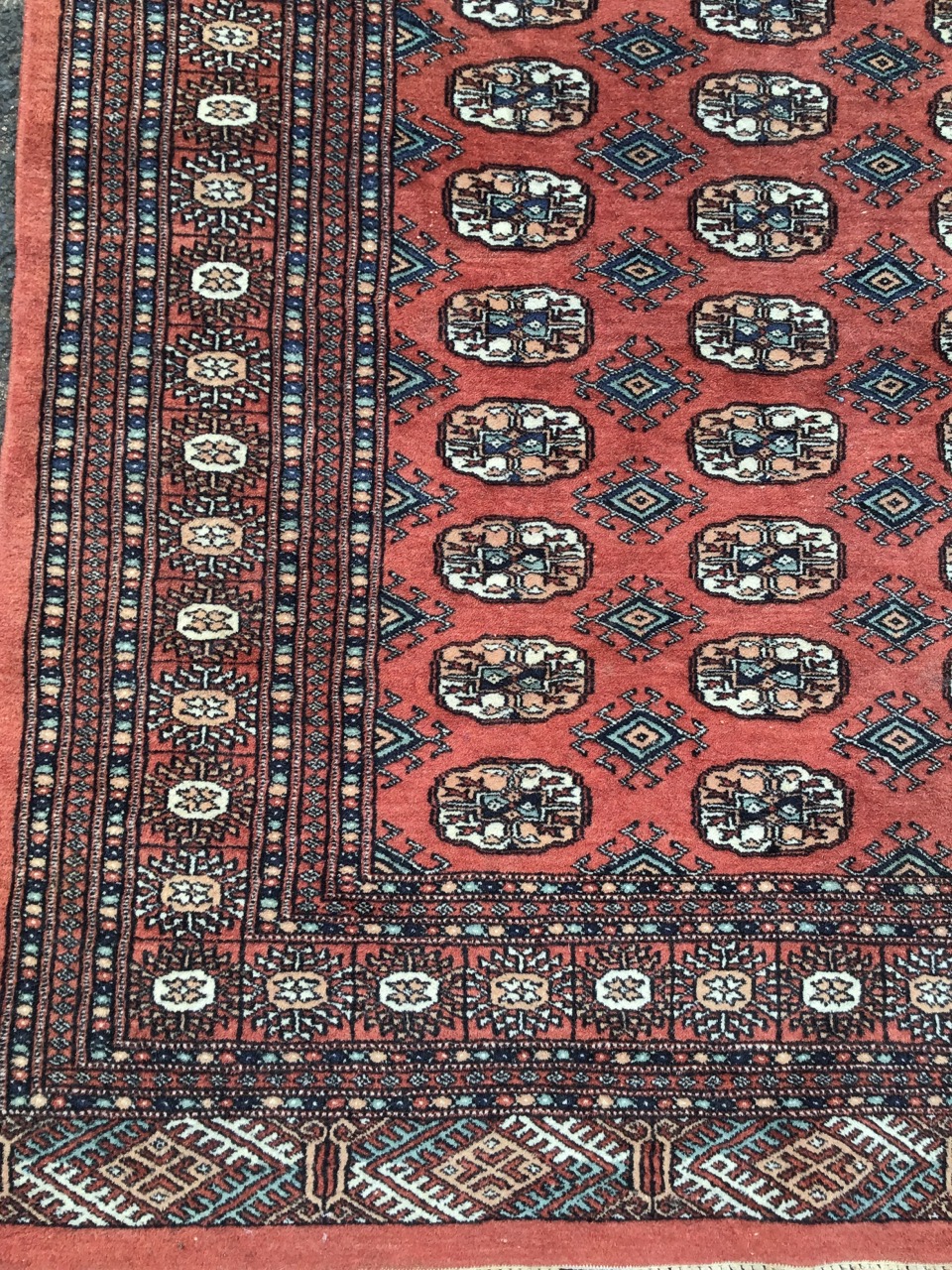 A bokarra type oriental rug woven with madder field of oval lozenges and hooked diamond - Image 3 of 3