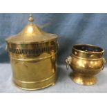 A cylindrical lidded brass coal scuttle with ring handles having pierced border to the rim, the