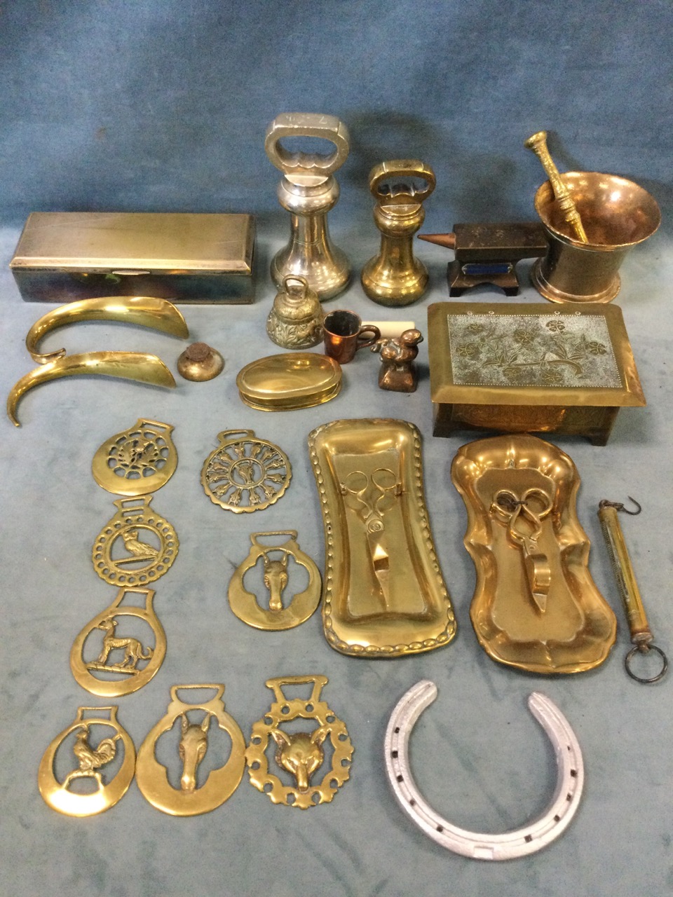 Miscellaneous brass - cigarette boxes, candle snuffers and trays, an anvil, pestle and mortar,