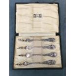 A set of four hallmarked silver lobster picks with flowerhead entwined handles by Liberty & Co, in
