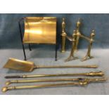 An iron and brass plate warming rack on curled feet; a pair of brass firedogs with urn finials on