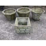 A set of three octagonal garden pots moulded with pebble finishes to sides - two with wrought iron