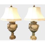 A pair of large tablelamps with octagonal fabric shades on four-handled fluted urns draped with