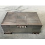 A rectangular hallmarked silver cigarette box with ribbed decoration and cedar lining, the feet