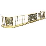 A Victorian brass fender with D-shaped rail on spindles with pierced fretwork dragon panels,