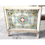 A late Victorian rectangular leaded stained glass window frame panel with central floral medallion