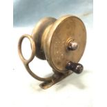 An early Mallochs brass reel with hinged line guide on shoe, with bell shaped spool and 3.25in drum.