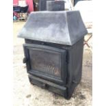 A cast iron stove with angled canopy above an arched glazed door, with panelled grate drawer