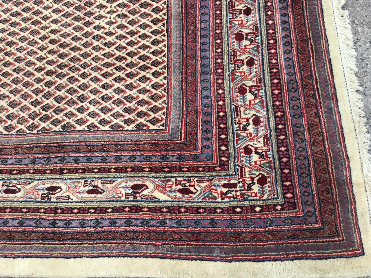 An Iranian carpet woven in the Arak style with fawn field of floral lozenges framed by multiple - Image 3 of 3