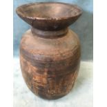 An ancient turned hardwood jar, the vessel with ribbed decoration and flared rim. (17.25in)