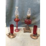 A pair of C19th Sheffield plate and cranberry glass storm lamps and snuffers, the scalloped bases