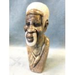 A carved stone African bust depicting a bearded gentleman. (10.25in)
