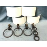 A set of three contemporary Jim Lawrence iron wall lights with crescent shaped canvas shades above