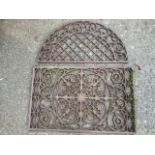 A iron door plate with circular pierced scrolled panel to rectangular frame, having elliptical