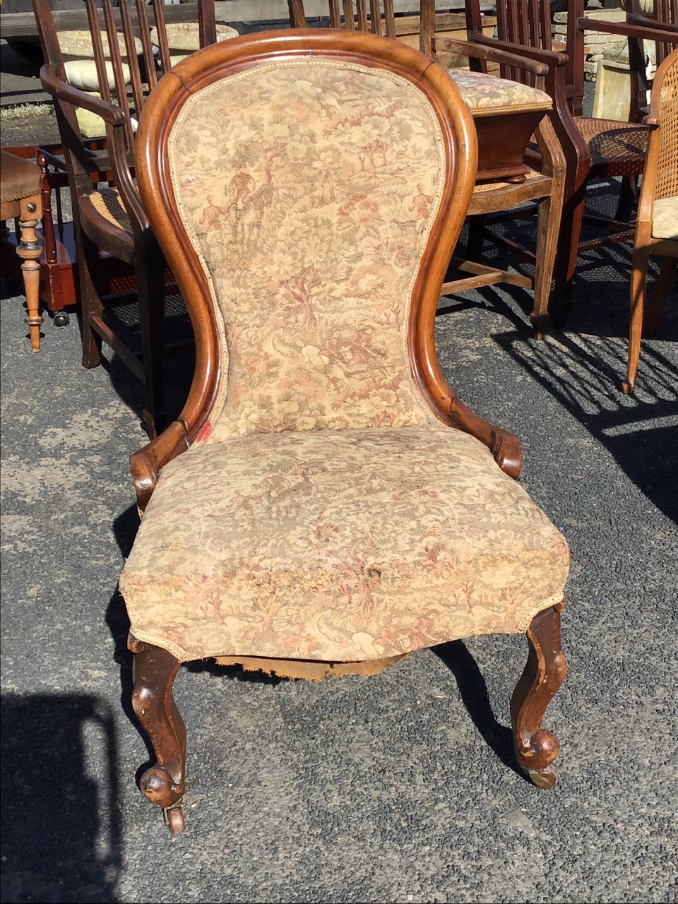 A Victorian mahogany upholstered spoonback chair with cushion moulded frame having carved terminals, - Image 2 of 3